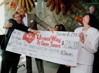 Premier Bob Rae hams it up with United Way campaign chief Ron Barbaro yesterday after presenting him with a cheque for $2,266,000 on behalf of Ontario(...)