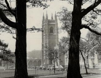 The Memorial Tower of the University of Toronto framed between trees in Queen's Park, Toronto