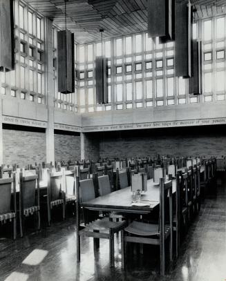 The great hall of the U. of T.'s new massey college. Japanese silk suspended in banner formation frames ceiling fixtures