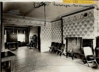 Interior of pass-through room with decorative wallpaper, hardwood floors and two mantels. Foldi ...