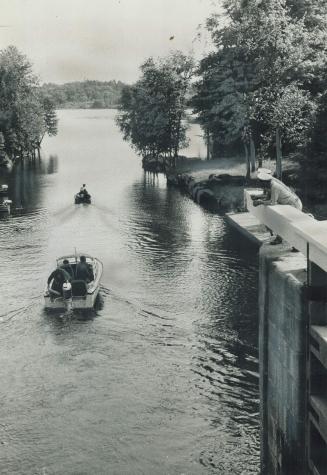 On the Rideau (left) pleasure boats come out of Chaffey's Locks on the old canal which links the historics cities of Kingston and Ottawa