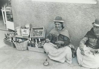 Bolivian Woman in La Paz spins wool at the market