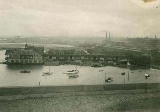 Image shows a view from the roof towards the Harbour. Some buildings, boats can be seen.