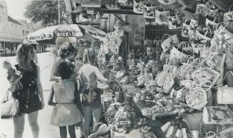 Women Tourists, who go shopping in this straw market at Nassau in the Bahamas