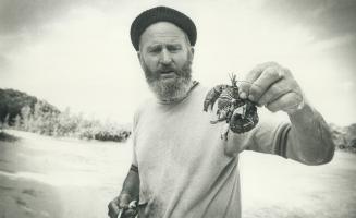 Tour escort Dick Gibb with crab catch for his meal