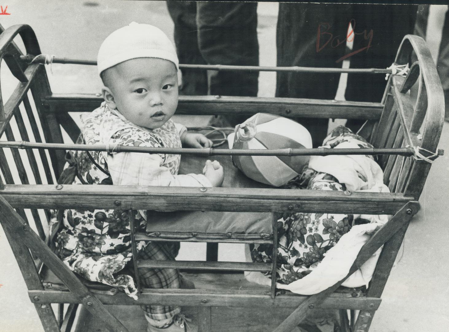Baby in a carriage in the Chinese capital of Peking was among the sights that greeted Prime Minister Pierre Trudeau and his wife, Margaret, on their recent visit there