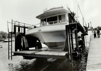 It's a squeeze as Starship is loaded aboard the rail car at Big Chute on the Trent Canal system with just a quarter of a inch to spare on each side. [Incomplete]