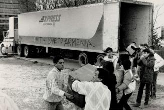 Metro volunteers, above, load supplies bound for Armenia