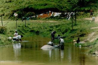 Washing clothes in the river on the Pacaveira Plantation