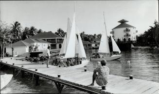 Enthusiastic vacationers set out for a sail from a dock at one of the resorts in Martinique, known for its good beaches