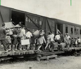 Chinese civilians board a train to escape advance of Japanese troops