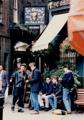 Youths gather for a British tradition - beer at a local pub