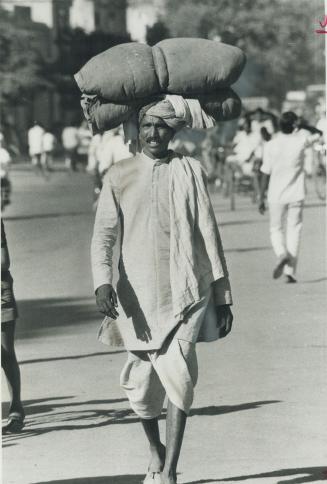 Despite the heat this Indian citizen goes about his tasks, carrying on his head a load that would stagger most North Americans. To ordinary people the(...)