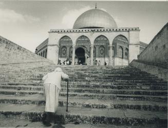 Abiding faith: A worshipper goes to East Jerusalem's Al-Aqsamosque, with its hotly contested Dome of the Rock, to pray
