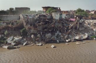 Cholera, Peru - houses along the banks of Riu Rimac, which runs through Lima