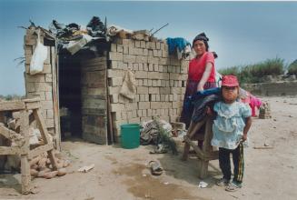 Lima Peru. Family living in hostily contructed humortared hut. They fled the mountains because of shinning path terrorists