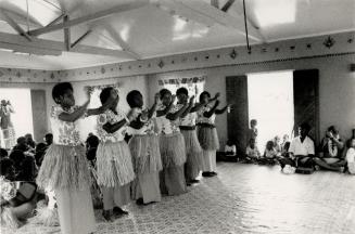 Dancers on Ways Island show missionary influence with long gowns under their grass skirts