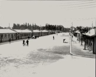 Almost three years after D-Day June 6, 1944, newly-built wooden houses line this street in Caen, France