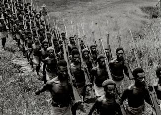 New Guinea natives on a route march