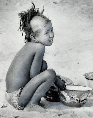 African child crouches in hunger during severe drought, Reader Richard lee, who worked in Africa, says Oxfam must be politically aware because poverty and politics go hand in hand