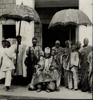Big umbrellas are an inevitable part of the grandeur of great native princes in Africa, whether on the banks of the Niger or Congo. Above, with his um(...)