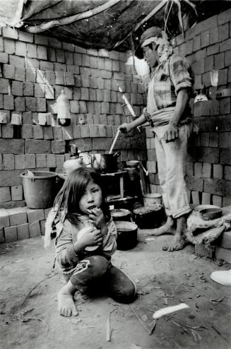 Agripina Yuincho, 6, and her father Agabito live in a barren hut hastily constructed from unmortared bricks