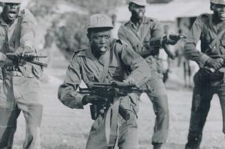 Young guerrilla fighter Ema Hakim strikes a ferocious pose as he drills with compatriots of the rebel Sudan People's Liberation Army at a base in the (...)
