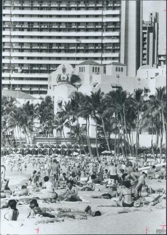 Wall-to-wall people pack the beach at Waikiki every day sun shines