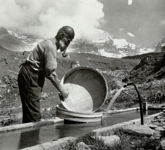 Right, an old cheesemaker washes his tubs in the Bernese Oberland