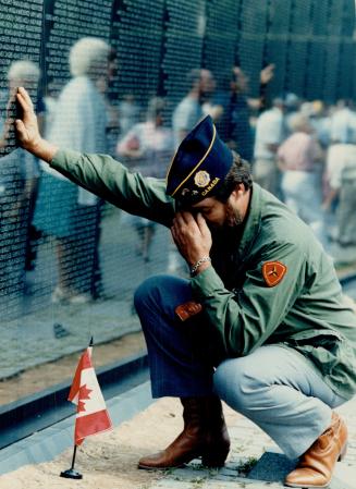 Viet Nam remembered: Taking a moment to recall lost friends, Alex Mills of Toronto kneels at the Viet Nam memorial in Washington yesterday