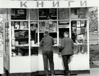 Two young men scan he wares at one of the thousands of book stores an kiosks in the Russian capital