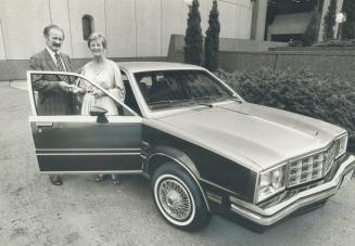 Her lucky number, Jan Davidson of Thornhill is handed the keys to her new Pontiac by Norm Kirk, Star advertising director, yesterday