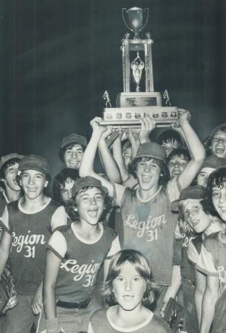 Spoils of victory: Winning pitcher Mark Zuolinski of York holds trophy emblematic of Toronto Star-CNE Peewee baseball championship as teammates cheer after beating Hamilton Police, 3-2, last night