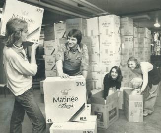 Helping sort boxes in the basement of the Scott Mission are Steve Trnavsky, 18, left, and Andy May, 18