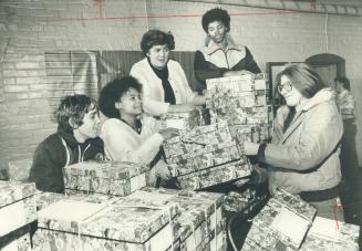 Barb Gibbons, left, Sheila Holmes, Chris Gibbons and Bonny Trites distribute boxes