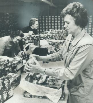 Racing the clock, seven workers are beginning final countdown at The Star Santa Claus Fund depot as they fill 21,000 gift boxes which will bring happi(...)