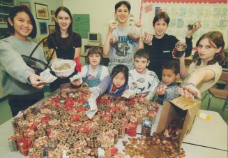 They're on a roll, Islington Junior Middle School pupils proudly display the $1,450 they've rolled together in a coin drive to help The Star's Santa C(...)