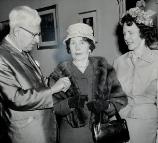 Runner-up in contest, Mrs. E. J. Norman, Roxborough St. W., has mink stole placed over shoulders by Mayor Phillips who made presentations
