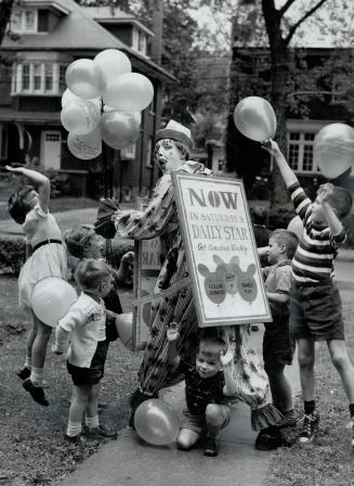 Cavorting children have gay time around clown whose sandwich board announces the Canadian Weekly, new magazine making its debut in Saturday's Star. Va(...)