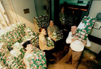 Helping hands: Star Publisher John Honderich shows boxes being loaded by, from left, Maria Faria, Marisa Rocha, Ken Rosa, Dave Areias, Robert Engel