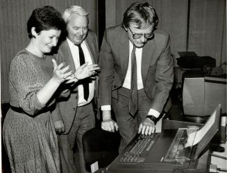 First prize, a $5,000 Olivetti word processor, is admired by winner Lynn Koza, Sunday Editor Gerry Hall and Jan Adamek, a marketing vice-president of Olivetti