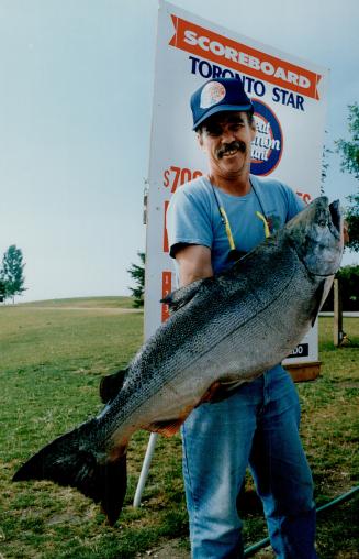 Don McCrae hoists the 38.74-pound chinook salmon he caught at 1:30 a.m. yesterday in Lake Ontario. It's the first entry in the 1991 Toronto Star Great(...)
