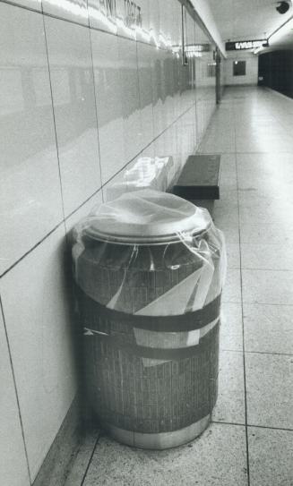 Taking no chances: Police have sealed garbage cans, like this one, in subway stations today as part of a massive security operation to protect the transit system from terrorists' bomb threats