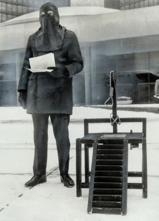 During the continuing debate on capital punishment, Jack Butterey of Edmonton tours Canadian cities, dressed as a hangman, with a two-foot scaffold as part of his campaign against hanging