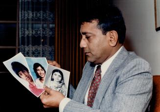 Grieving father: Arup Das gazes at photos of his wife and two children who died in the Air-India crash in June