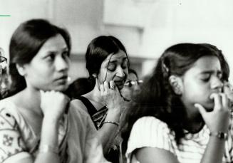 Bengali's grief: Maya Mallick, centre, wipes away tears yesterday during a prayer memorial for friends and relatives killed in last Sunday's Air-India jet disaster
