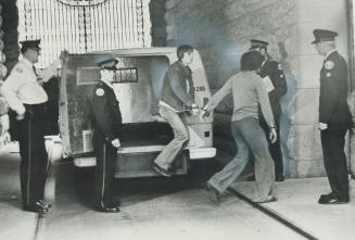 Police lead handcuffed suspected drug traffickers into station after a Metro-wide round-up of people believed involved in illegal narcotic trade early(...)