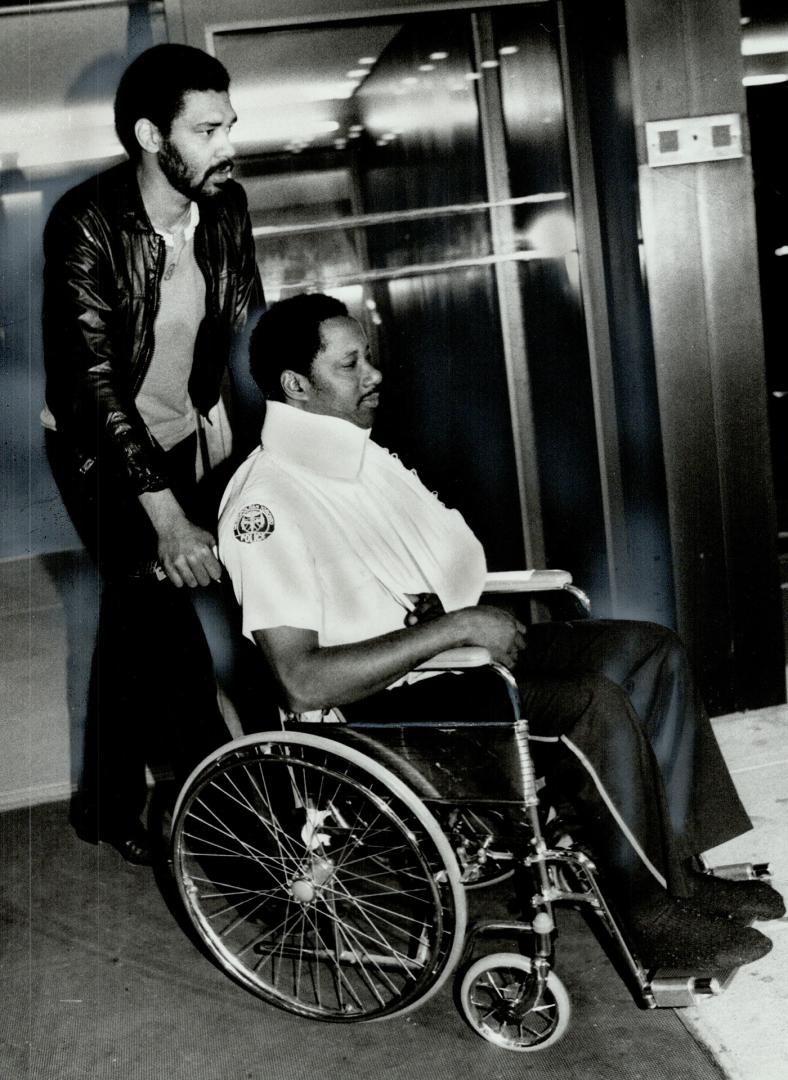 Injured by debris: Constable Mervin Dennis (in wheelchair) is one of the 23 Division policemen injured by flying debris when the bomb went off at Litton Systems