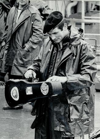 Recognized case: When an Ottawa man spotted this photo of anIrish soldier carrying a violin case he realized it belonged to a close friend who had perished in the Air-India crash