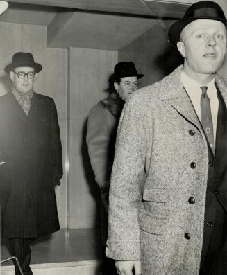 Finaciers D. Hubert Cox Hugh Paton behind RCMP officer (right), Arrested and charged with Conspiracy to Steel $400,000